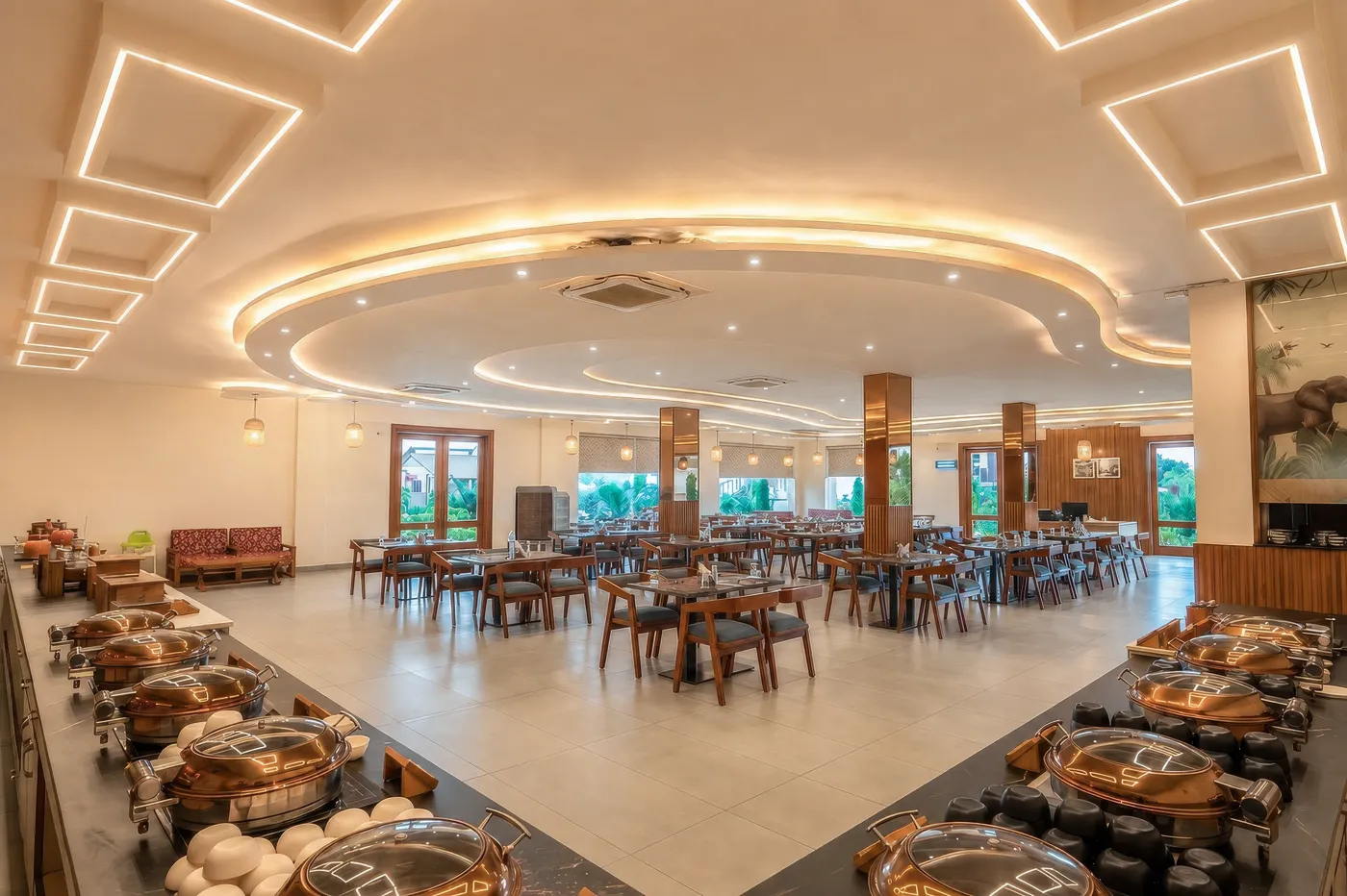 Evara Restaurant dining hall with timber chairs and panoramic windows onto the garden